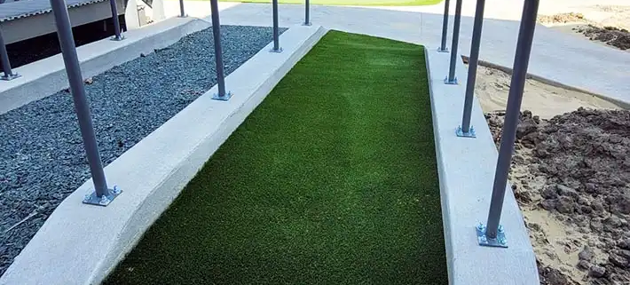 commercial synthetic turf runway in between 2 railings
