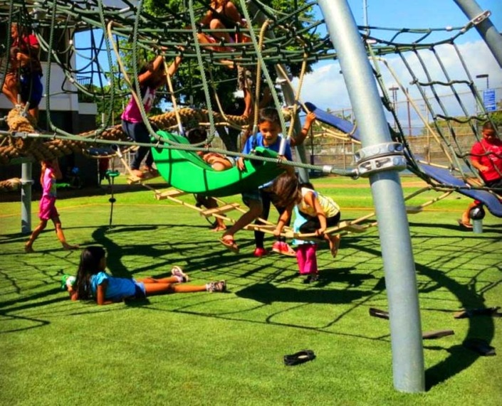children playing on a synthetic turf playground