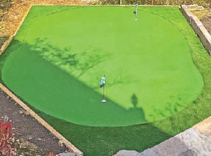 aerial view of a diy backyard putting green kit with 2 holes.