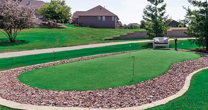 outdoor putting green with rock landscaping