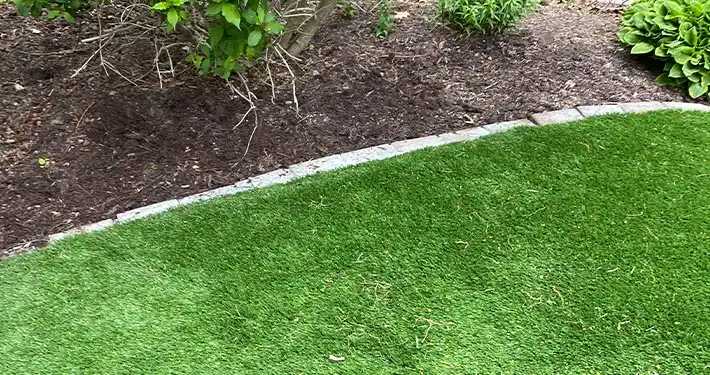 close up of fake grass and mulch landscaping for business