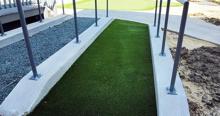 commercial synthetic turf runway in between 2 railings