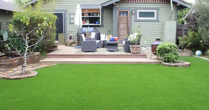 patio area with furniture and a fake turf yard