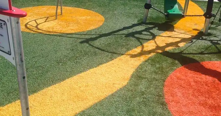 close up aerial shot of playground turf with a colorful design