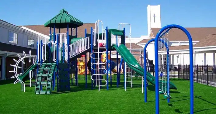 artificial grass outdoor play area with slide and jungle gym